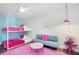 A colorful bedroom features a bunk bed, a couch, and bright pink accents at 2001 25Th W Ave, Bradenton, FL 34205