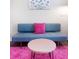 Comfortable sitting area has a blue couch and a fluffy rug at 2001 25Th W Ave, Bradenton, FL 34205
