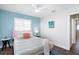This vibrant bedroom boasts a ceiling fan, plush pillows, and natural light from the window at 2001 25Th W Ave, Bradenton, FL 34205