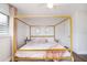 The bedroom features a modern canopy bed, neutral rug, and bright light at 2001 25Th W Ave, Bradenton, FL 34205