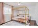 The bedroom features a modern canopy bed, neutral rug, and bright light at 2001 25Th W Ave, Bradenton, FL 34205