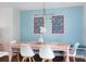 Dining room features a pink table, unique lighting and light blue accent wall at 2001 25Th W Ave, Bradenton, FL 34205