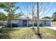 This single-story home features a well-manicured lawn, a red front door, and a welcoming exterior at 2001 25Th W Ave, Bradenton, FL 34205