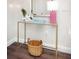 Hallway featuring a glass-top desk with stylish decor and a wicker basket, highlighting modern design at 2001 25Th W Ave, Bradenton, FL 34205