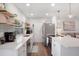 The kitchen features quartz countertops, stainless appliances, and modern pendant lighting at 2001 25Th W Ave, Bradenton, FL 34205