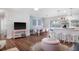 Open-concept living and dining area with stylish furnishings, bright lighting, and hardwood floors throughout at 2001 25Th W Ave, Bradenton, FL 34205