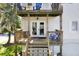 Two-story porch with wooden railings and stairs, complemented by vibrant blue seating at 2003 12Th W Ave, Bradenton, FL 34205