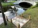 Backyard with stone steps and a tranquil canal view, creating a peaceful outdoor space at 2003 12Th W Ave, Bradenton, FL 34205