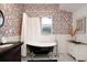 Charming bathroom features a classic clawfoot tub, stylish vanity, and floral wallpaper at 2003 12Th W Ave, Bradenton, FL 34205
