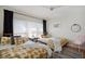 Bright bedroom with two twin beds, modern decor, and ample natural light from large windows at 2003 12Th W Ave, Bradenton, FL 34205