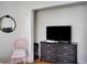 Bedroom featuring television and dresser with a pink chair to the side at 2003 12Th W Ave, Bradenton, FL 34205