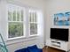 Cozy room with large windows, a modern TV stand, and plush seating for relaxation at 2003 12Th W Ave, Bradenton, FL 34205