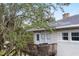Charming upper deck with a grill, offering a view of the lush greenery and the rest of the property at 2003 12Th W Ave, Bradenton, FL 34205