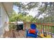 Outdoor deck features a grill, seating, and views of the surrounding trees at 2003 12Th W Ave, Bradenton, FL 34205