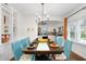 Elegant dining room with stylish blue chairs, a rustic table, and bright natural light at 2003 12Th W Ave, Bradenton, FL 34205