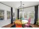 Bright dining room with colorful chairs, a modern light fixture, and natural light at 2003 12Th W Ave, Bradenton, FL 34205
