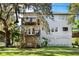 White two-story home with multiple decks, complemented by lush greenery and blue skies at 2003 12Th W Ave, Bradenton, FL 34205