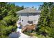 Two-story home with mature trees and multiple wooden decks and stairs at 2003 12Th W Ave, Bradenton, FL 34205
