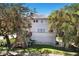 Charming multi-story home with decks, a well-maintained lawn, and mature trees at 2003 12Th W Ave, Bradenton, FL 34205