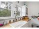 Close up of kitchen featuring a farmhouse sink and colorful backsplash at 2003 12Th W Ave, Bradenton, FL 34205