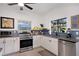 Modern kitchen with white cabinets, stainless steel appliances, and stylish countertops at 2003 12Th W Ave, Bradenton, FL 34205