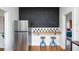 Kitchen area with stainless steel refrigerator, chalkboard wall, and breakfast bar at 2003 12Th W Ave, Bradenton, FL 34205