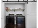 Laundry room featuring a side-by-side washer and dryer and a barn door at 2003 12Th W Ave, Bradenton, FL 34205