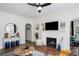 Bright living room with fireplace, modern ceiling fan, and lots of natural light at 2003 12Th W Ave, Bradenton, FL 34205