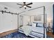 Primary bedroom featuring a four-poster bed, a ceiling fan, and a barn door to the closet at 2003 12Th W Ave, Bradenton, FL 34205