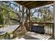 Relaxing porch with a comfortable porch swing, showcasing beautiful mature trees at 2003 12Th W Ave, Bradenton, FL 34205