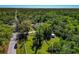 Aerial view of a home surrounded by lush greenery and mature trees offering serene privacy at 2070 59Th St, Sarasota, FL 34243