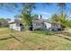 View of home's backyard featuring fenced yard, mature trees, and well-maintained lawn at 2070 59Th St, Sarasota, FL 34243