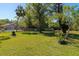 Expansive backyard with lush green grass, mature trees, and white picket fence at 2070 59Th St, Sarasota, FL 34243