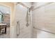 Updated shower with grab bars and tiled walls and shower head with removable wand at 2070 59Th St, Sarasota, FL 34243