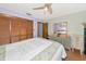 Cozy bedroom featuring wood floors, a ceiling fan, ample closet space, and soft, soothing colors at 2070 59Th St, Sarasota, FL 34243