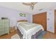 Comfortable bedroom with wood floors, ceiling fan, palm tree decoration, and closet space at 2070 59Th St, Sarasota, FL 34243