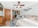 Comfortable bedroom featuring ceiling fan, warm colored walls, and adjacent kitchenette space at 2070 59Th St, Sarasota, FL 34243