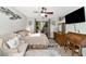 Cozy bedroom featuring a ceiling fan, dresser, desk, and sliding glass doors to the outside at 2070 59Th St, Sarasota, FL 34243