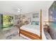 Cozy bedroom with four poster bed, sliding glass doors leading to a private outdoor space at 2070 59Th St, Sarasota, FL 34243