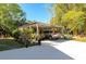 Carport accommodating two vehicles, surrounded by lush greenery and vegetation at 2070 59Th St, Sarasota, FL 34243