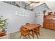 Dining room with beach themed decor, a wooden dining set, and a large wooden hutch at 2070 59Th St, Sarasota, FL 34243