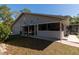 Charming home exterior with attached garage and screened-in porch, perfect for outdoor living at 2070 59Th St, Sarasota, FL 34243