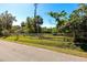 Quaint country home featuring a white picket fence and mature trees at 2070 59Th St, Sarasota, FL 34243