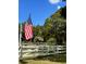Well-manicured front yard with a white picket fence and a vibrant American flag at 2070 59Th St, Sarasota, FL 34243