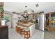Bright kitchen featuring a wooden island with seating, stainless steel appliances, and ample counter space at 2070 59Th St, Sarasota, FL 34243