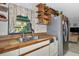 Cozy kitchen featuring wood countertops, stainless steel appliances, and ample natural light from the window at 2070 59Th St, Sarasota, FL 34243