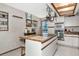 Well-lit kitchen with center island, hanging pot rack, and modern appliances at 2070 59Th St, Sarasota, FL 34243