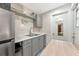 Kitchenette featuring gray cabinets, stainless steel appliances, marble countertops, and eat in table at 2070 59Th St, Sarasota, FL 34243