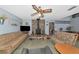 Inviting living room with a striking stone fireplace, comfortable seating, and a ceiling fan at 2070 59Th St, Sarasota, FL 34243