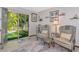 Comfortable living room with sliding door to back yard and featuring two armchairs and side tables at 2070 59Th St, Sarasota, FL 34243